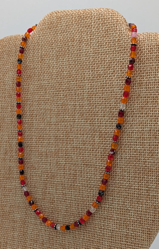Beaded necklace on a beige fabric background