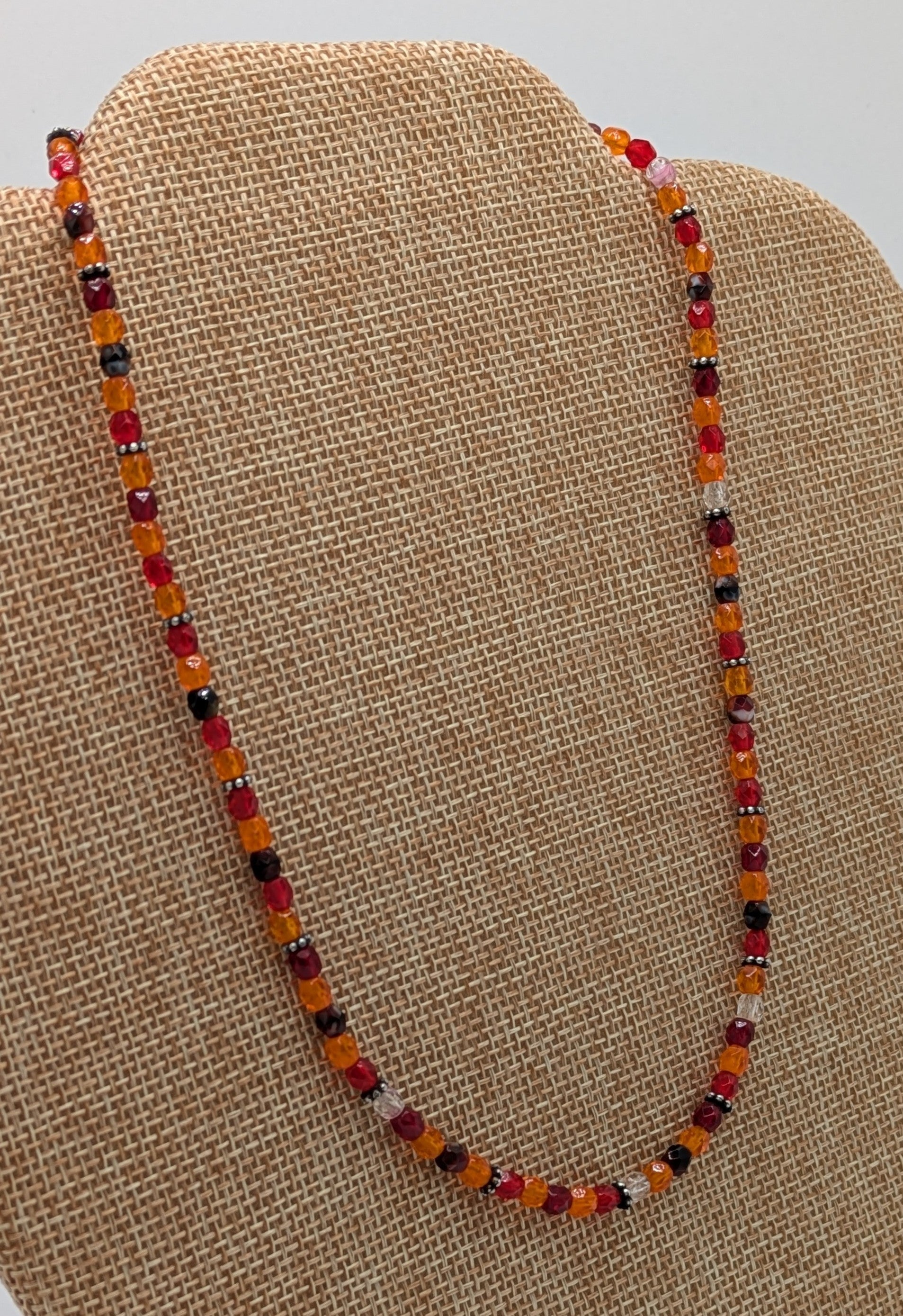 Beaded necklace on a brown display stand